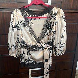 black lace neckline light pink blouse that wraps around the waist.